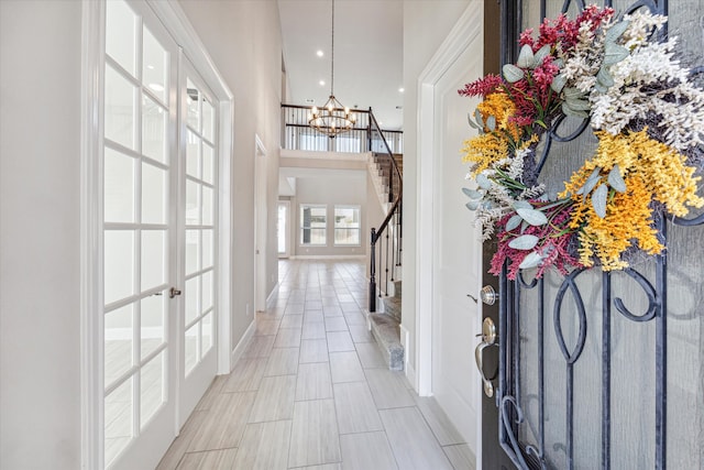 entryway featuring a notable chandelier and french doors