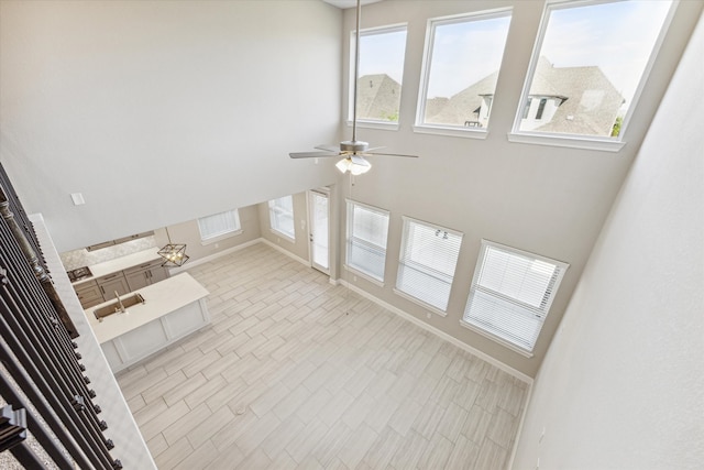 unfurnished living room with ceiling fan