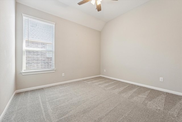 spare room featuring ceiling fan, lofted ceiling, and carpet flooring