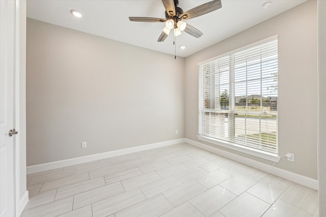 unfurnished room with ceiling fan and a wealth of natural light