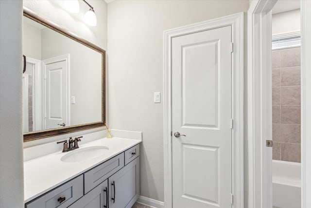 bathroom with vanity and a tub