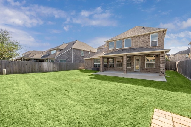 rear view of property featuring a patio and a yard