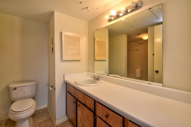 bathroom with tile patterned flooring, vanity, and toilet