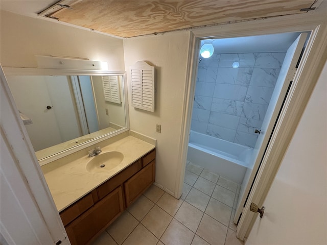 bathroom with tiled shower / bath combo, vanity, and tile patterned floors