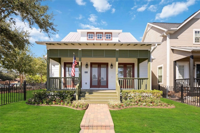 view of front of property featuring covered porch and a front yard