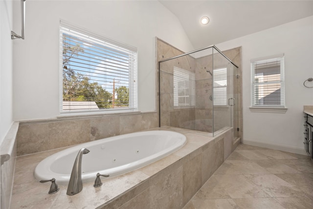 bathroom featuring a wealth of natural light, shower with separate bathtub, vanity, and vaulted ceiling