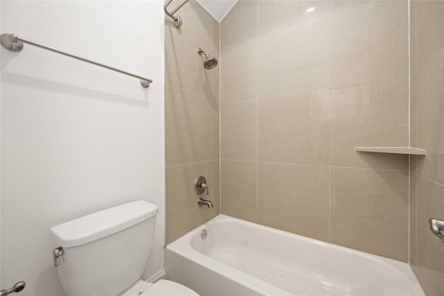 bathroom featuring tiled shower / bath and toilet