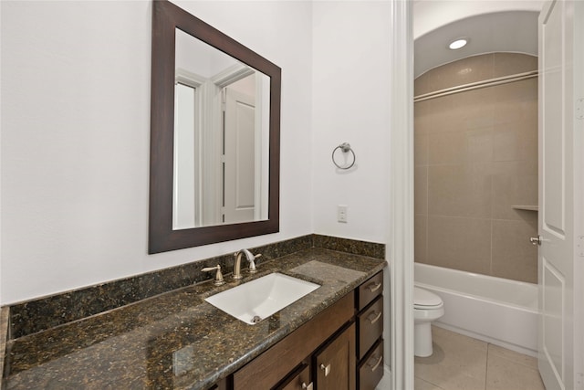 full bathroom with vanity, tile patterned flooring, toilet, and tiled shower / bath