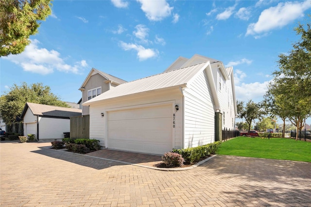 view of property exterior with a lawn and a garage