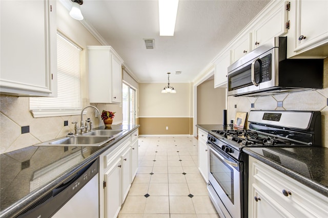 kitchen featuring appliances with stainless steel finishes, sink, and white cabinetry