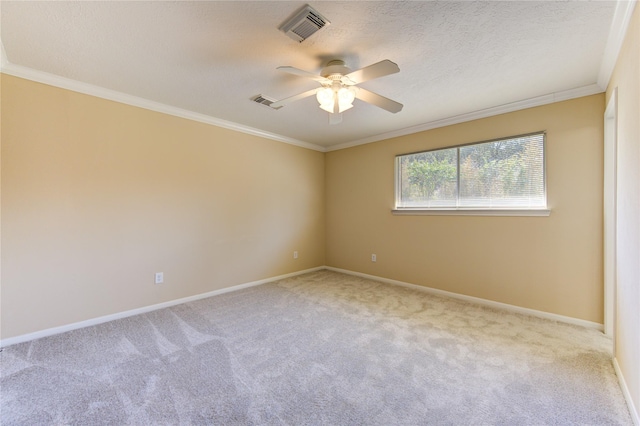 carpeted empty room with ceiling fan, ornamental molding, and a textured ceiling