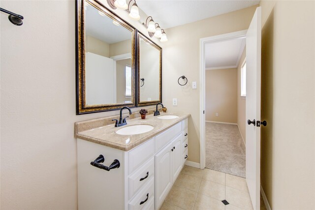 bathroom with tile patterned flooring, ornamental molding, and vanity