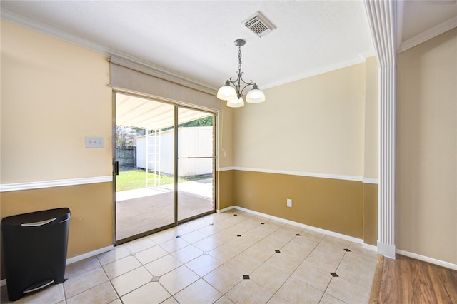 unfurnished dining area featuring an inviting chandelier and crown molding