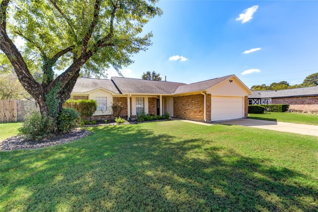 ranch-style house featuring a garage and a front yard