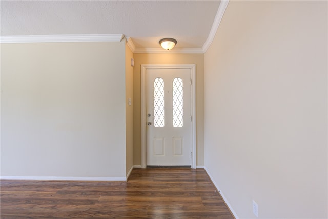 foyer entrance with dark wood-type flooring, ornamental molding, and a textured ceiling