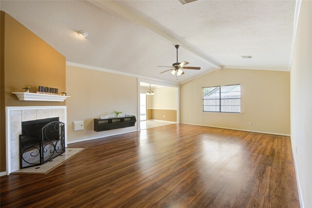 unfurnished living room featuring ceiling fan, a fireplace, hardwood / wood-style floors, and lofted ceiling with beams