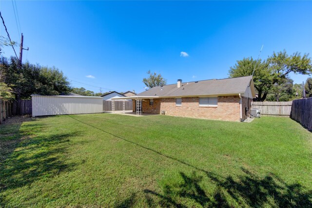 view of yard featuring a patio area and central AC