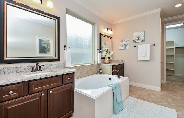 bathroom featuring crown molding, tile patterned flooring, a bathing tub, and vanity