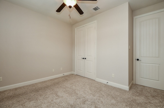 unfurnished bedroom featuring light carpet and ceiling fan