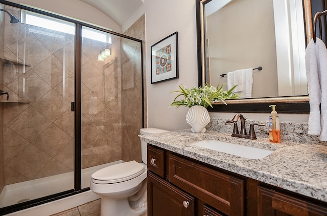 bathroom featuring walk in shower, vanity, and toilet