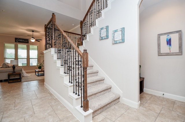 stairs featuring ornamental molding and ceiling fan