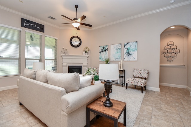 living room with ceiling fan and crown molding