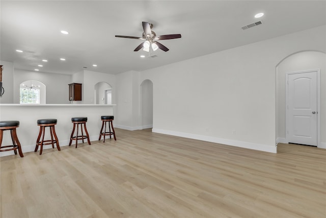 living room featuring light wood-type flooring and ceiling fan