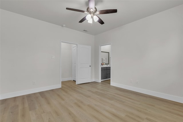 unfurnished bedroom featuring connected bathroom, light hardwood / wood-style floors, and ceiling fan