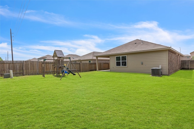 view of yard with a playground and central AC