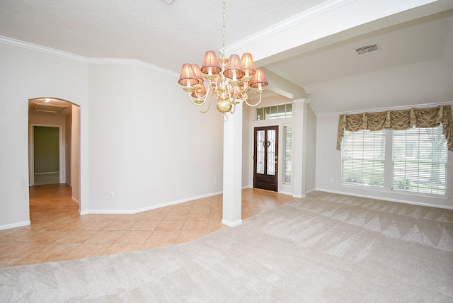 carpeted foyer entrance featuring an inviting chandelier, a textured ceiling, and ornamental molding