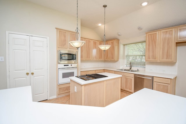 kitchen with pendant lighting, sink, appliances with stainless steel finishes, light brown cabinetry, and vaulted ceiling