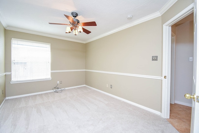 unfurnished room featuring ornamental molding, ceiling fan, light colored carpet, and a healthy amount of sunlight