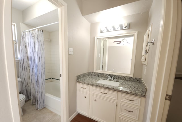 full bathroom featuring shower / bath combo, ceiling fan, vanity, and toilet