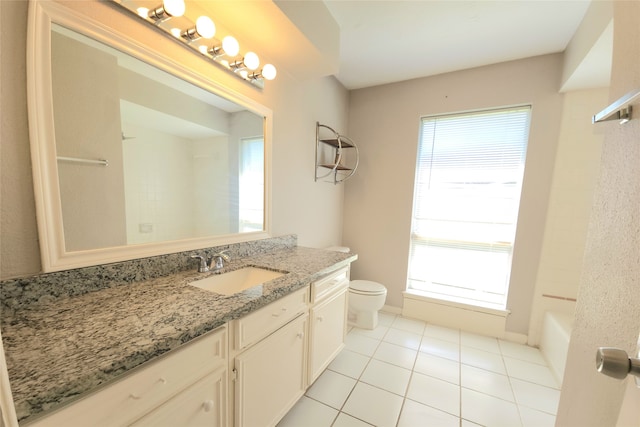 bathroom with vanity, tile patterned floors, a healthy amount of sunlight, and toilet