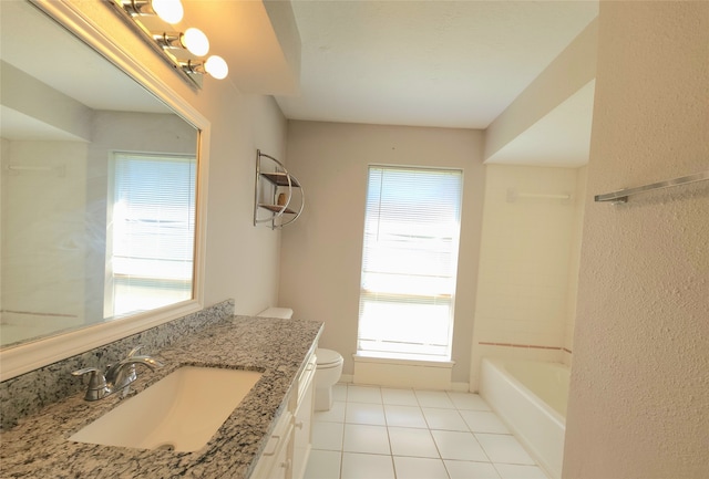 bathroom with tile patterned flooring, vanity, toilet, and plenty of natural light