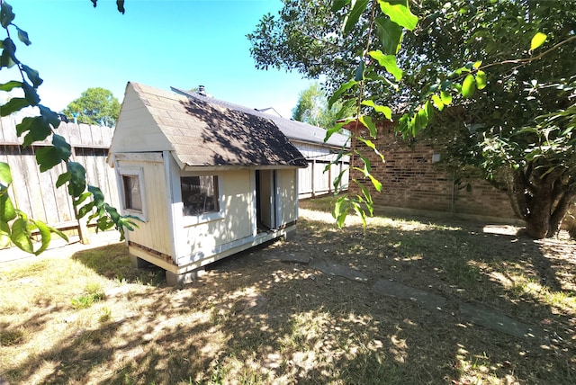 rear view of property featuring an outdoor structure