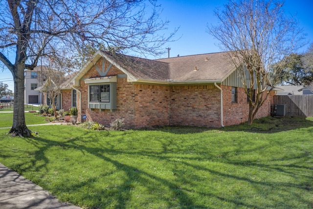 view of front of property with central AC unit and a front yard