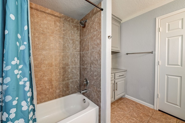 bathroom featuring vanity, tile patterned flooring, shower / bath combo, and a textured ceiling