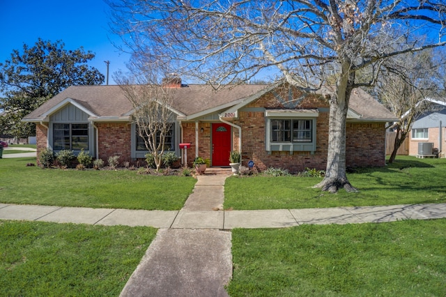 ranch-style home with central air condition unit and a front lawn