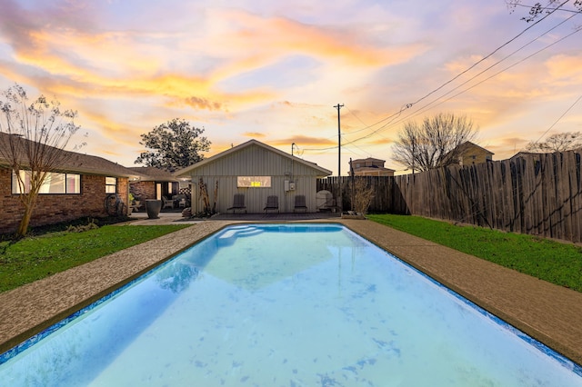 pool at dusk with a patio