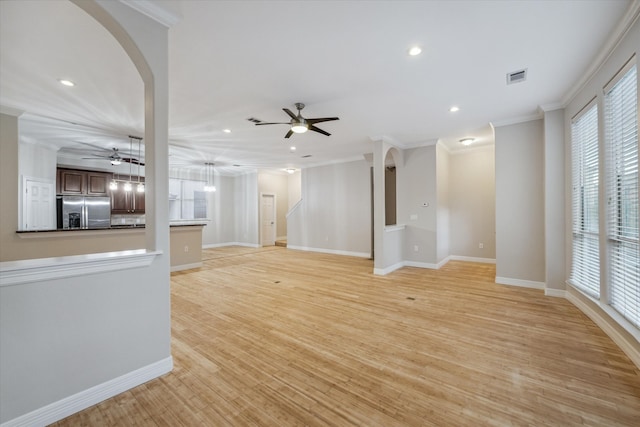 unfurnished living room featuring crown molding, light hardwood / wood-style floors, and ceiling fan