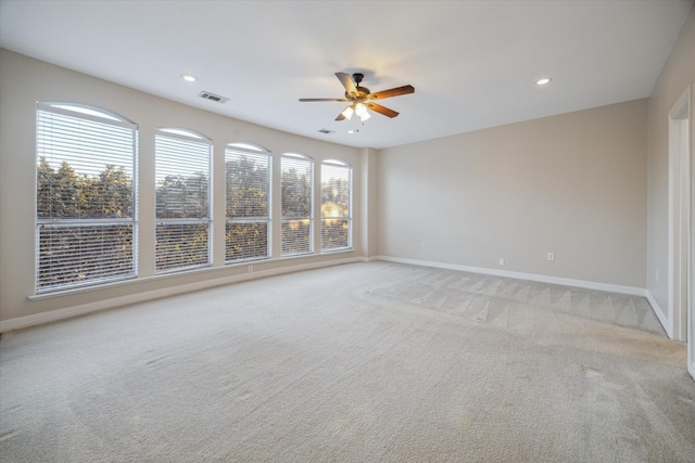 carpeted spare room with ceiling fan