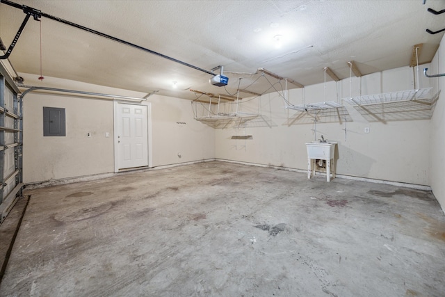 garage with a garage door opener, electric panel, and sink