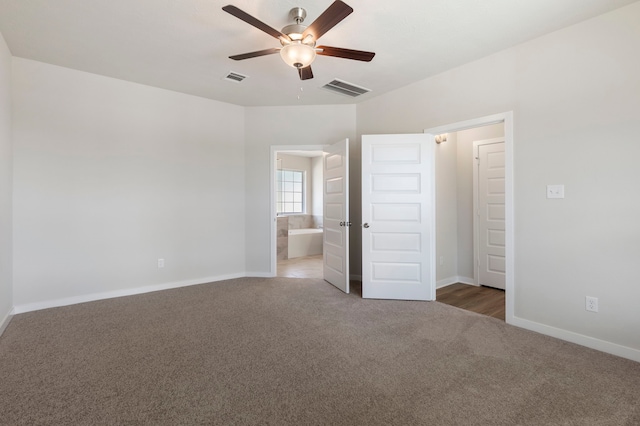 unfurnished bedroom featuring connected bathroom, carpet floors, and ceiling fan