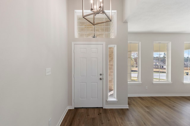 entryway featuring an inviting chandelier and dark hardwood / wood-style flooring