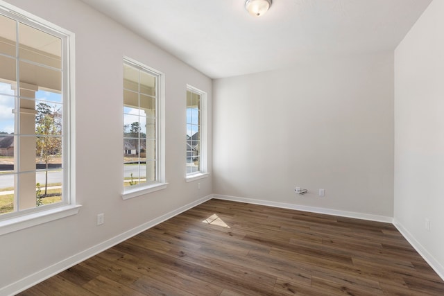 spare room with dark hardwood / wood-style floors