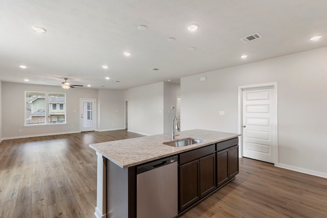 kitchen with dark brown cabinetry, sink, a center island with sink, dishwasher, and hardwood / wood-style floors