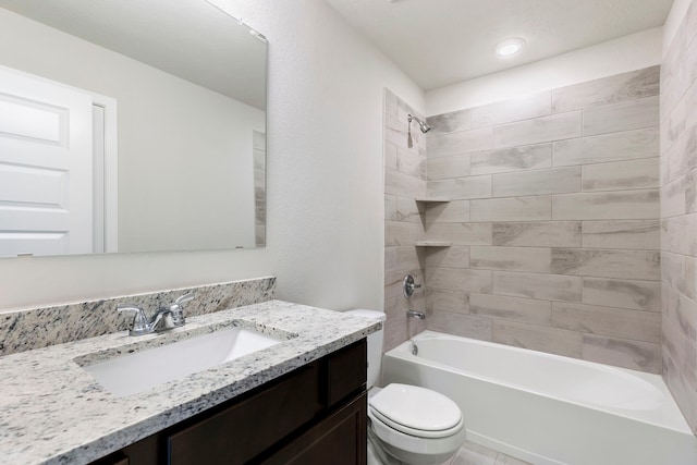 full bathroom with tiled shower / bath, vanity, and toilet