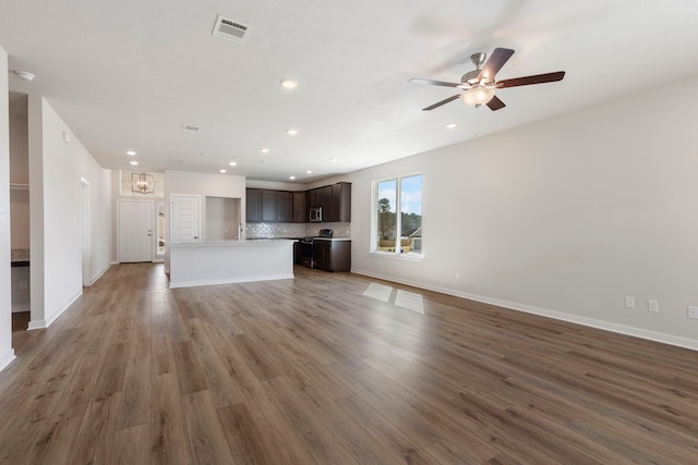 unfurnished living room with dark wood-type flooring and ceiling fan