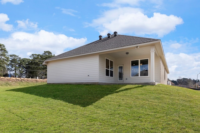 back of property featuring a yard